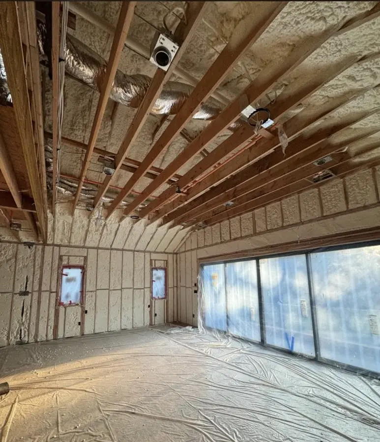 Interior walls and ceiling insulated with spray foam during new construction in Norton Shores